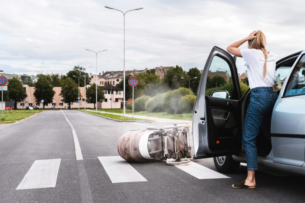 a woman standing in the middle of a road with a car on the side