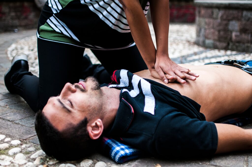 a man lying on the ground with hands on the chest