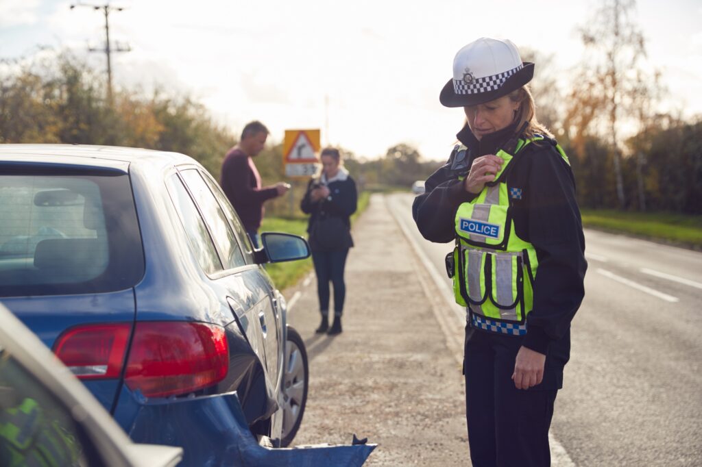 a police officer standing on the side of a road