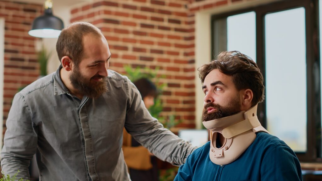 a man looking at another man with a neck brace