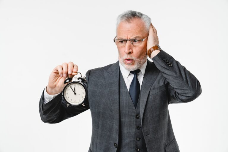 Shocked businessman grandfather lawyer holding clock for deadline, time is out, limited project