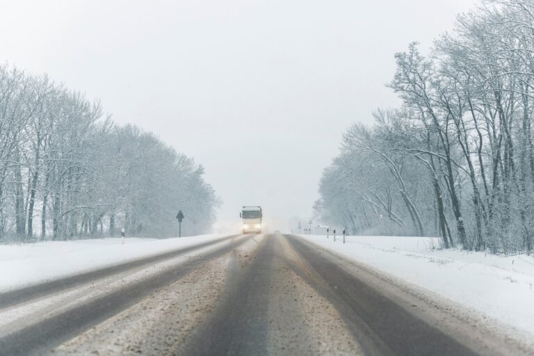 Scenic view snow covered intercity highway slippery snow covered road drive cars moving slowly