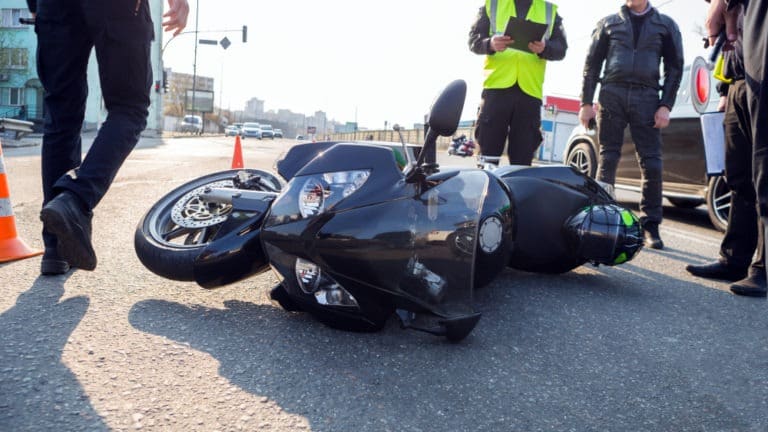 motorcycle lying in the road after crash