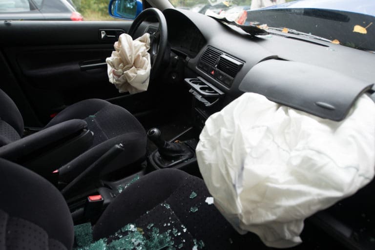 smashed car with deployed airbags