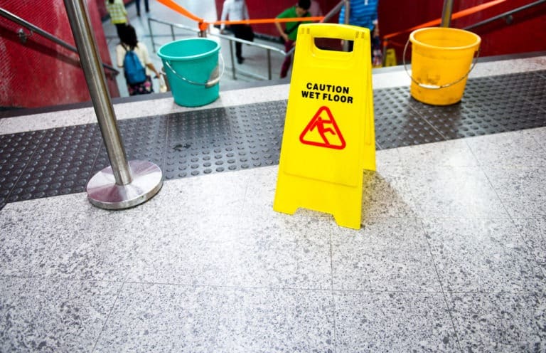 wet floor sign by stairs