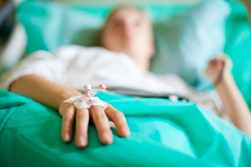 person lying in a hospital bed