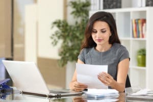 woman reviewing paperwork in her office