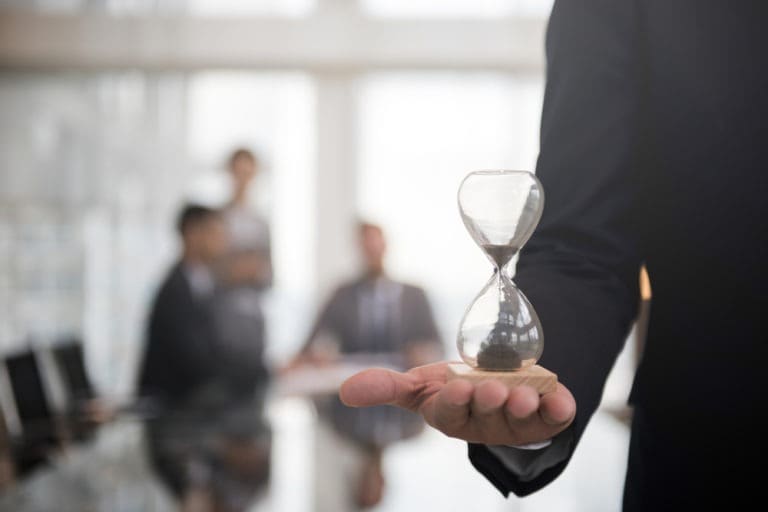personal injury lawyer holds hourglass in palm