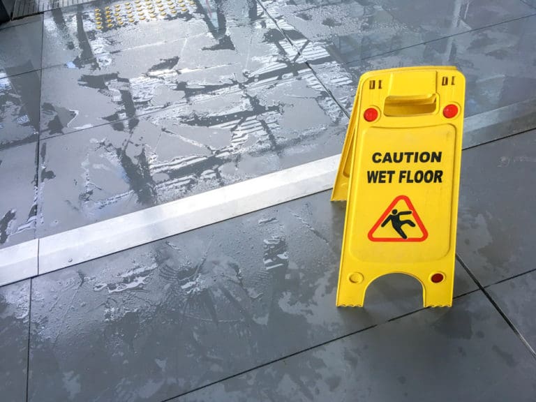 wet floor sign near a wet floor
