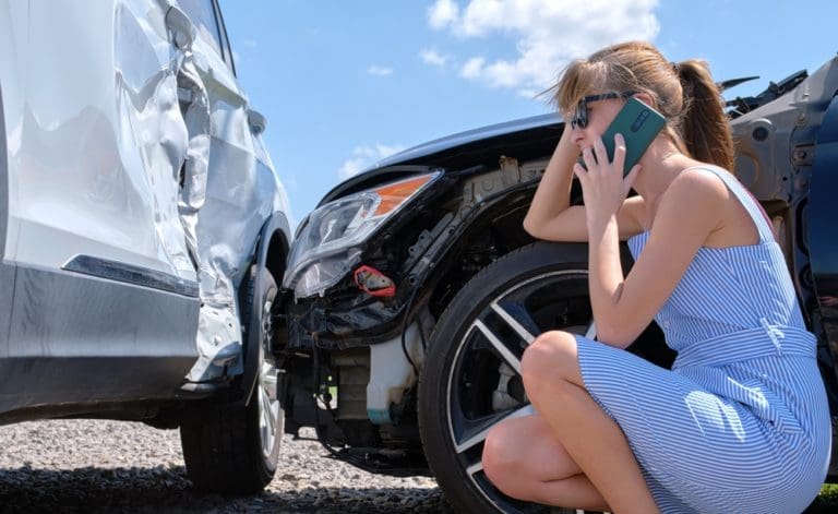 woman on phone dealing with car accident