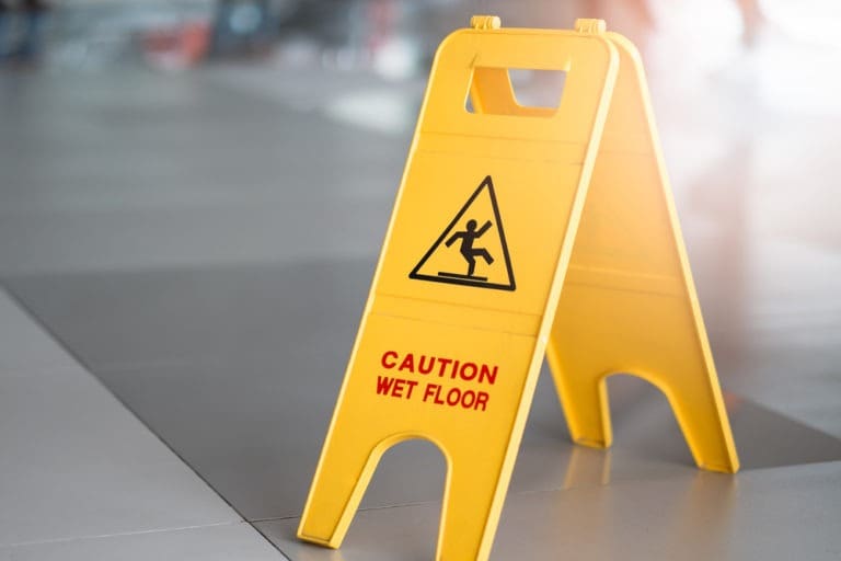 close-up on a wet floor sign