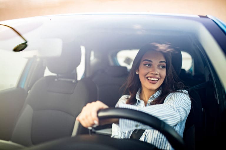 happy woman driving a car