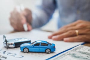 person signing a car insurance contract