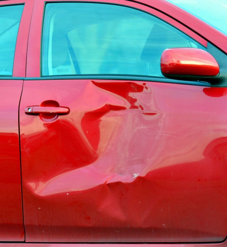 red car with side-impact damage