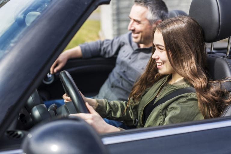 teen driver with her dad