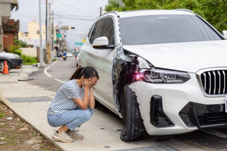 Distraught Woman Observes Car Accident Damage