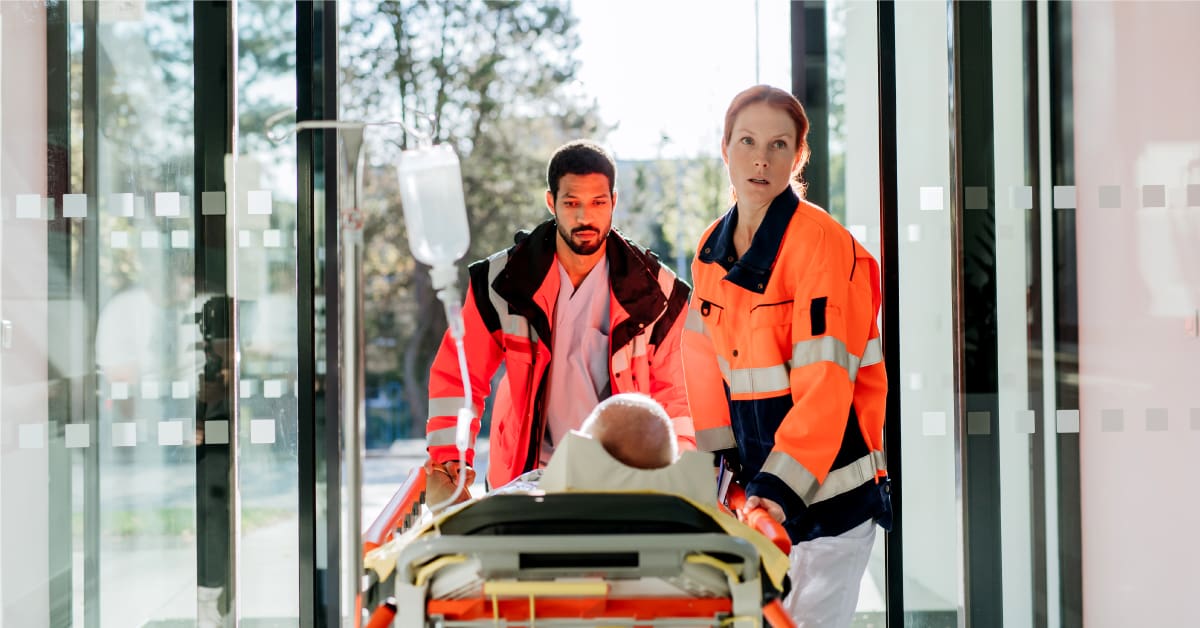 Paramedics carry a patient from an accident