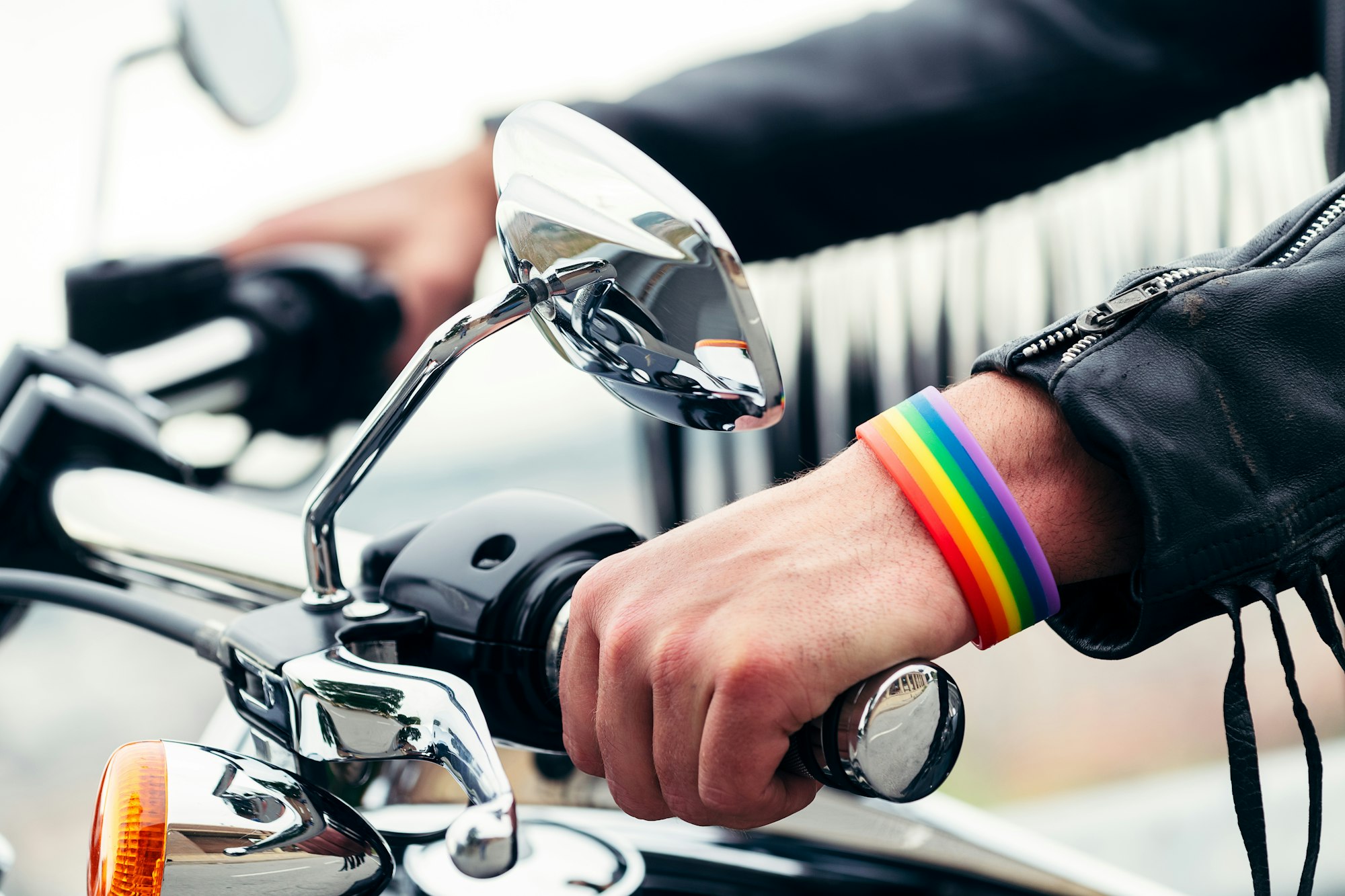 close up of hands of a man with rainbow bracelet