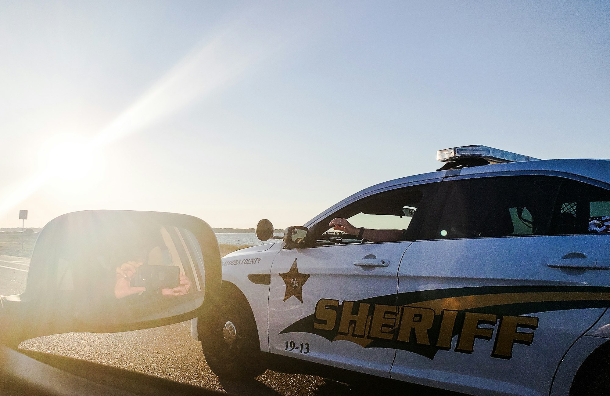 Law enforcement on the move on highway transfers a drunk tourist to jail and slows for traffic .