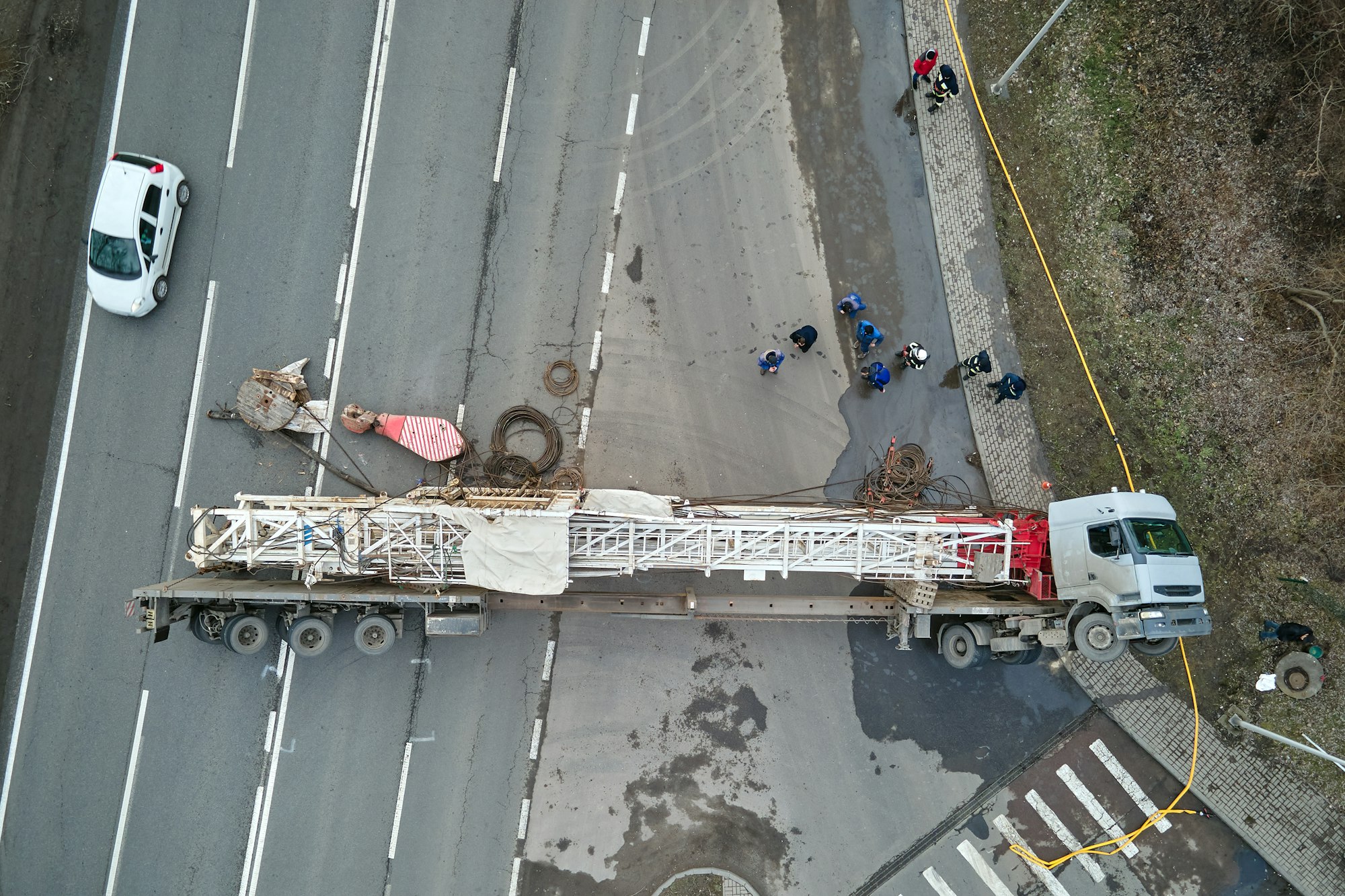 Aerial view of road accident with overturned truck blocking traffic