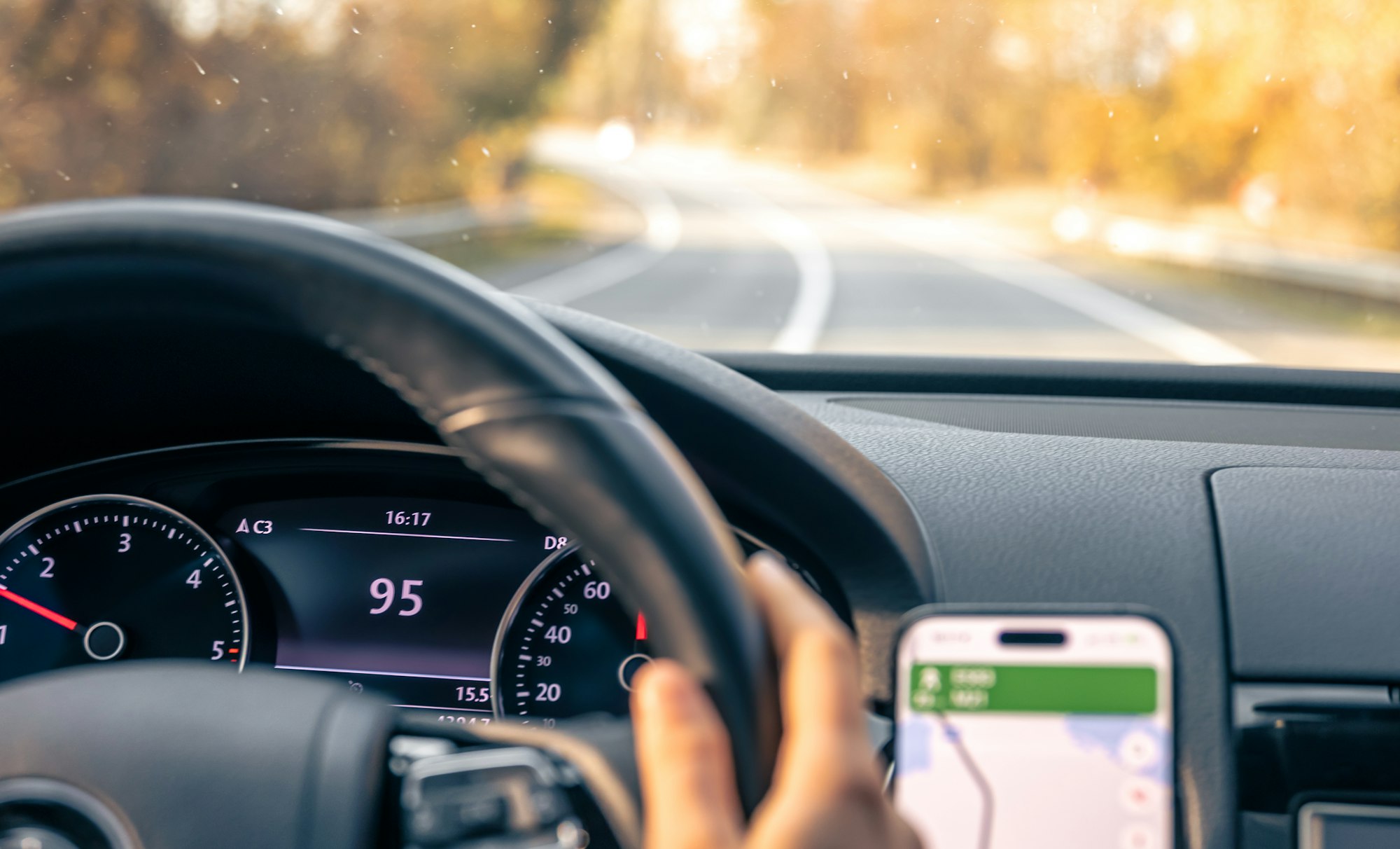 Steering wheel in a car close up, high speed driving on the road.