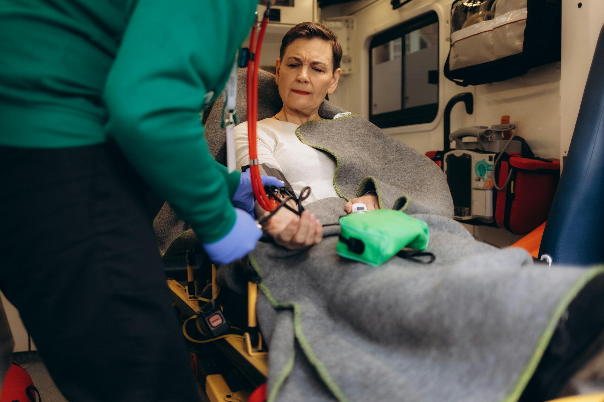 A doctor checks the pressure inside an ambulance
