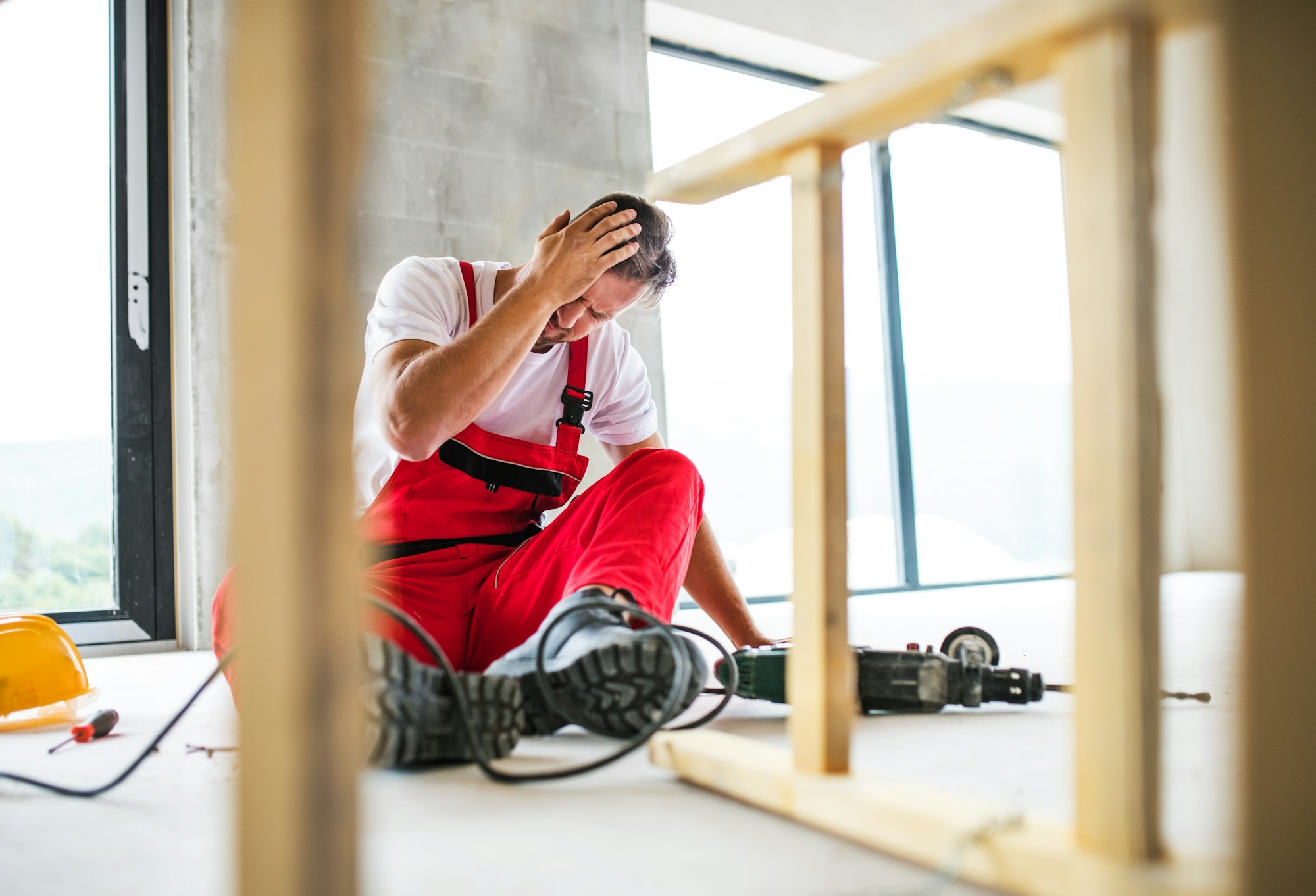 An accident of a man worker at the construction site.