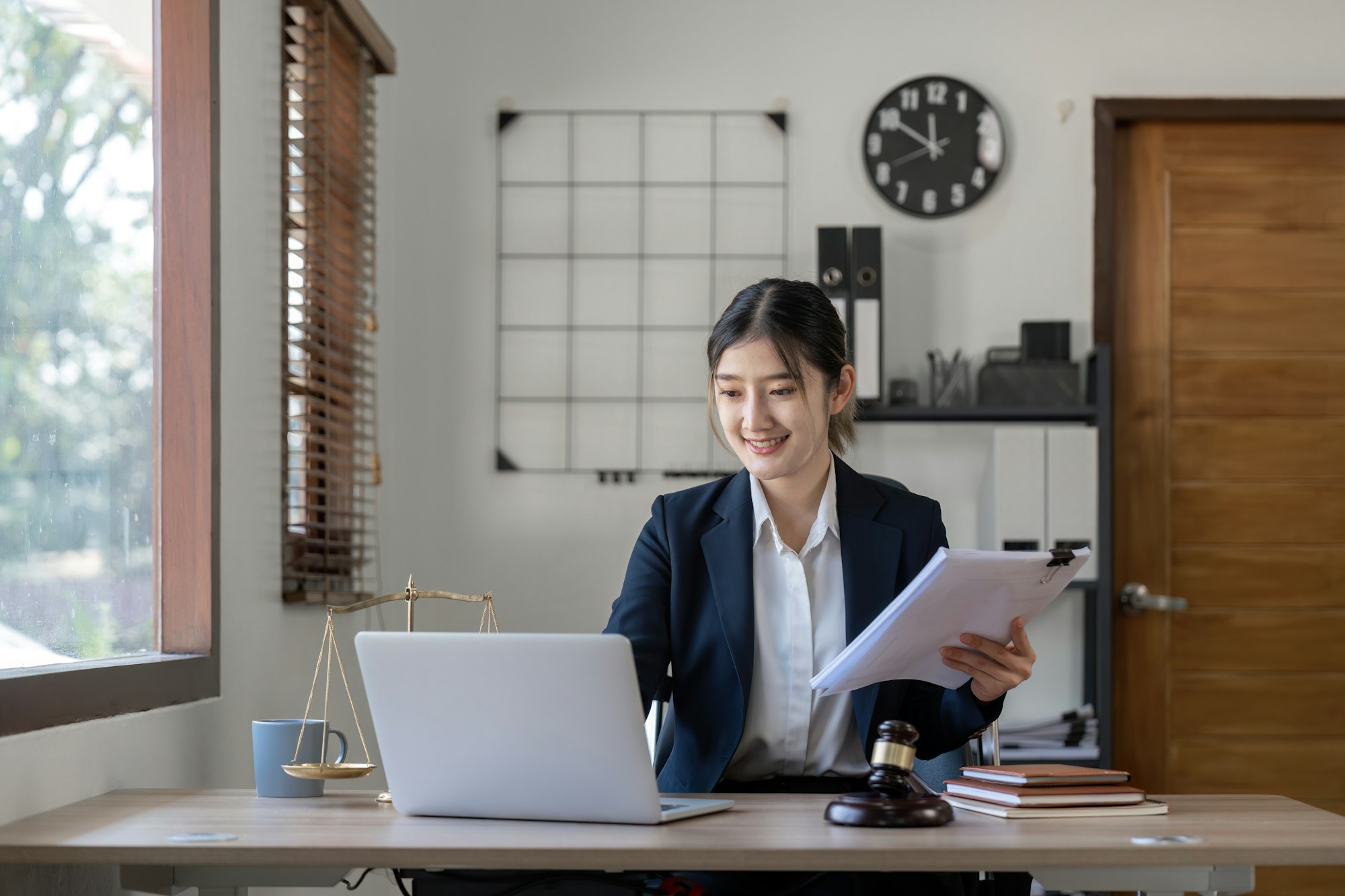 Attractive young lawyer in office Business woman and lawyers discussing contract papers with brass