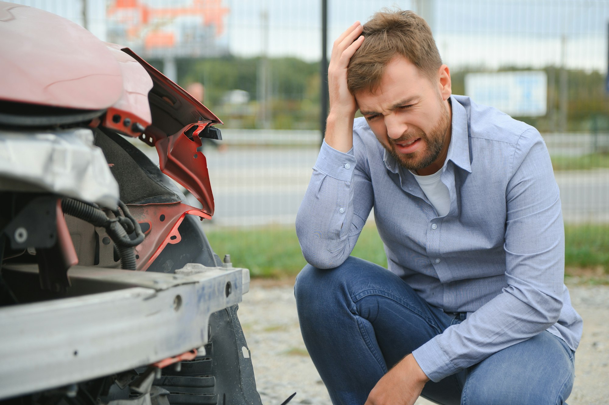 Car accident. Man after car accident. Man regrets damage caused during car wreck