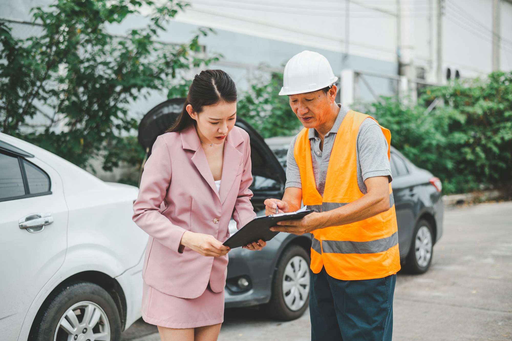 male insurance officer came to help inspect a customer's car that had an accident