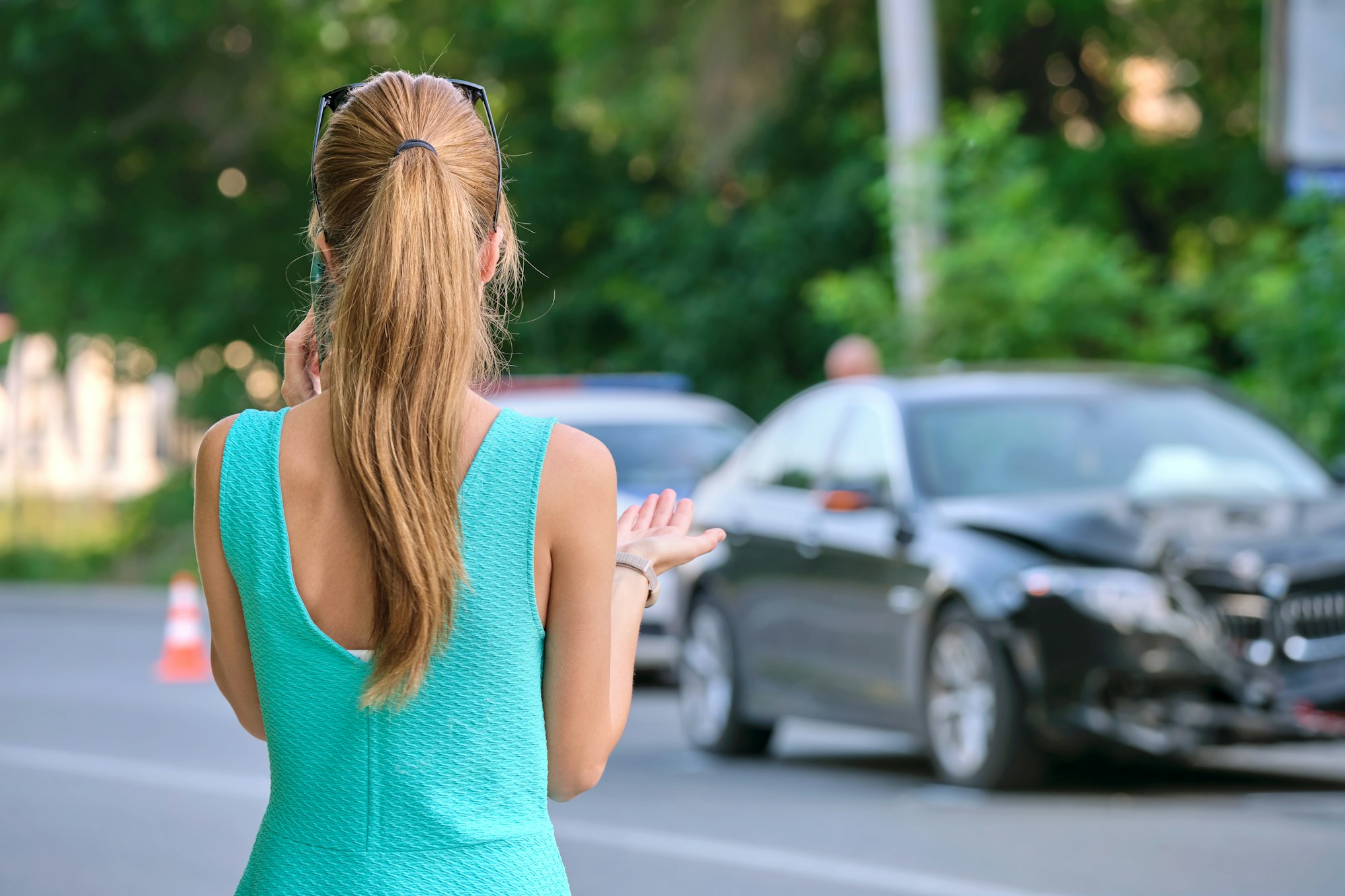 Stressed woman driver talking on mobile phone on street side calling for emergency service