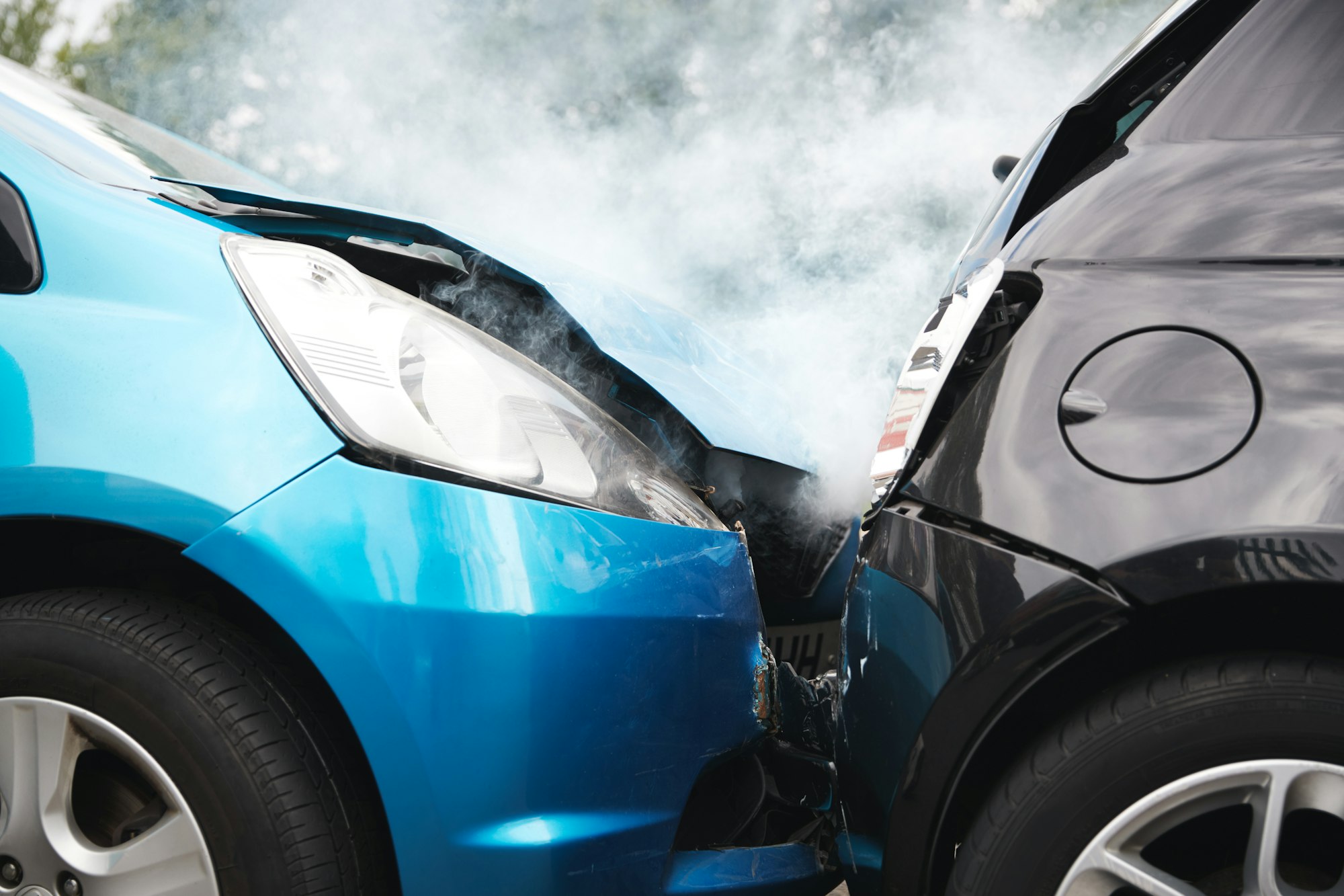 Close Up Of Two Cars Damaged In Road Traffic Accident