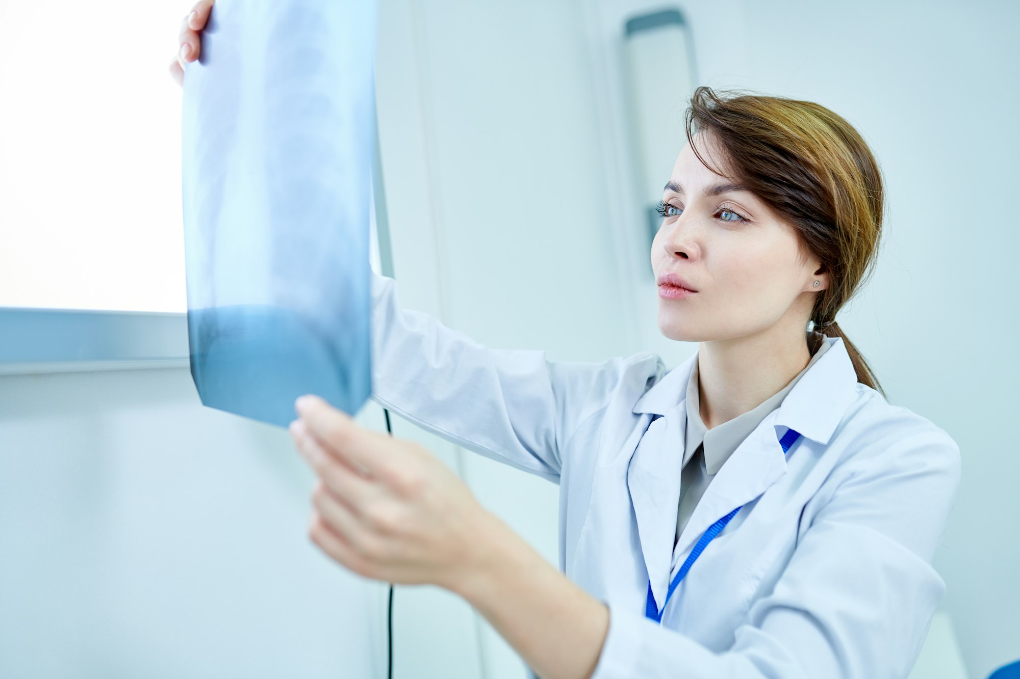 Doctor looking attentively at X-ray of chest