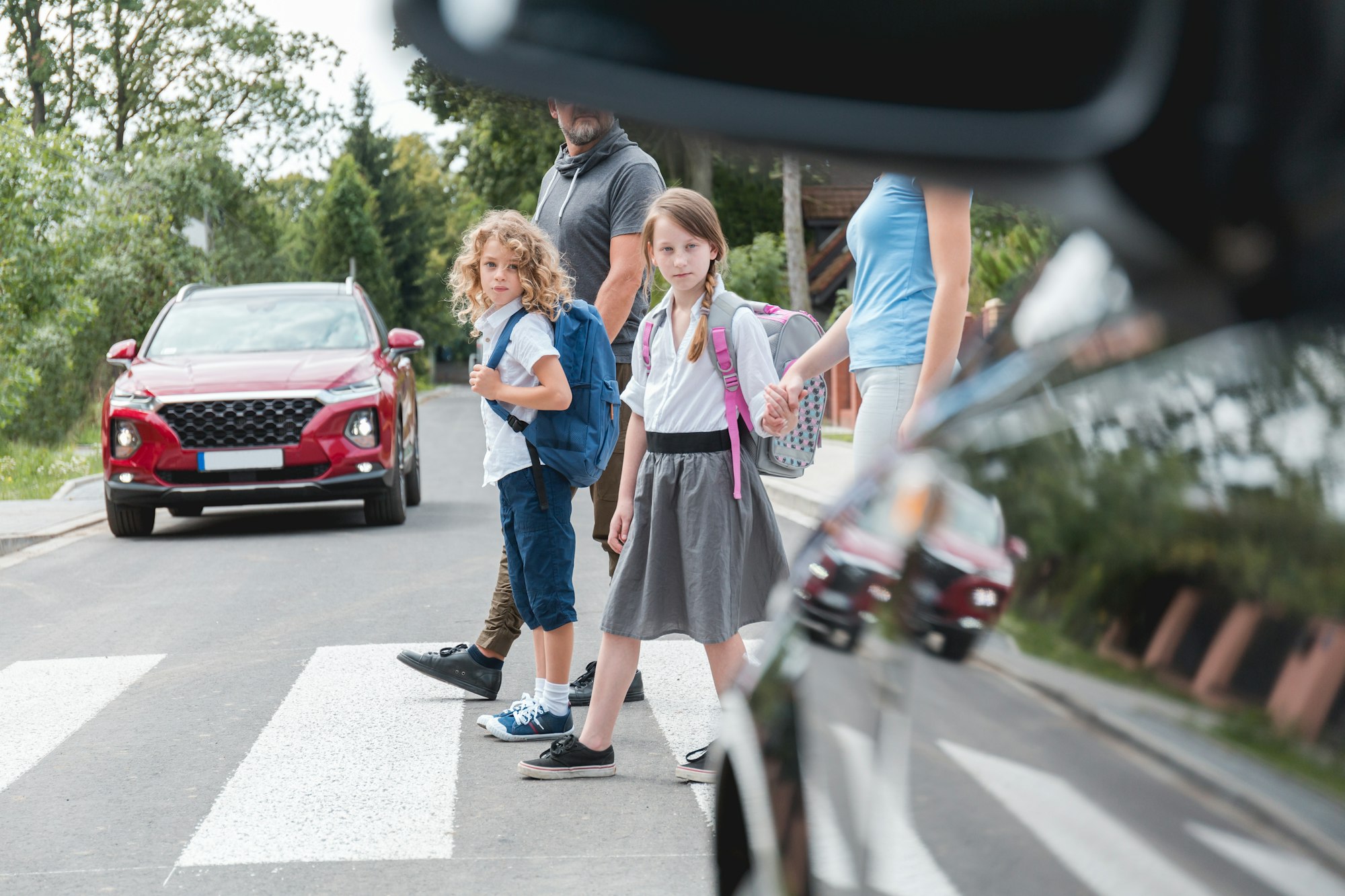 Group of children goes through the pedestrian crossing