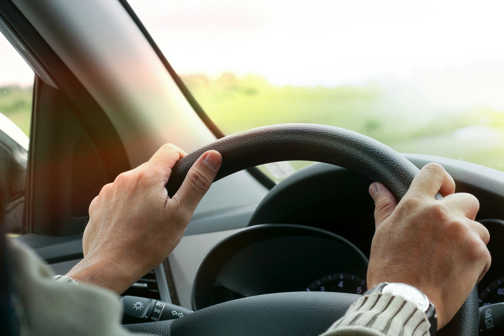 Hand of man driving car