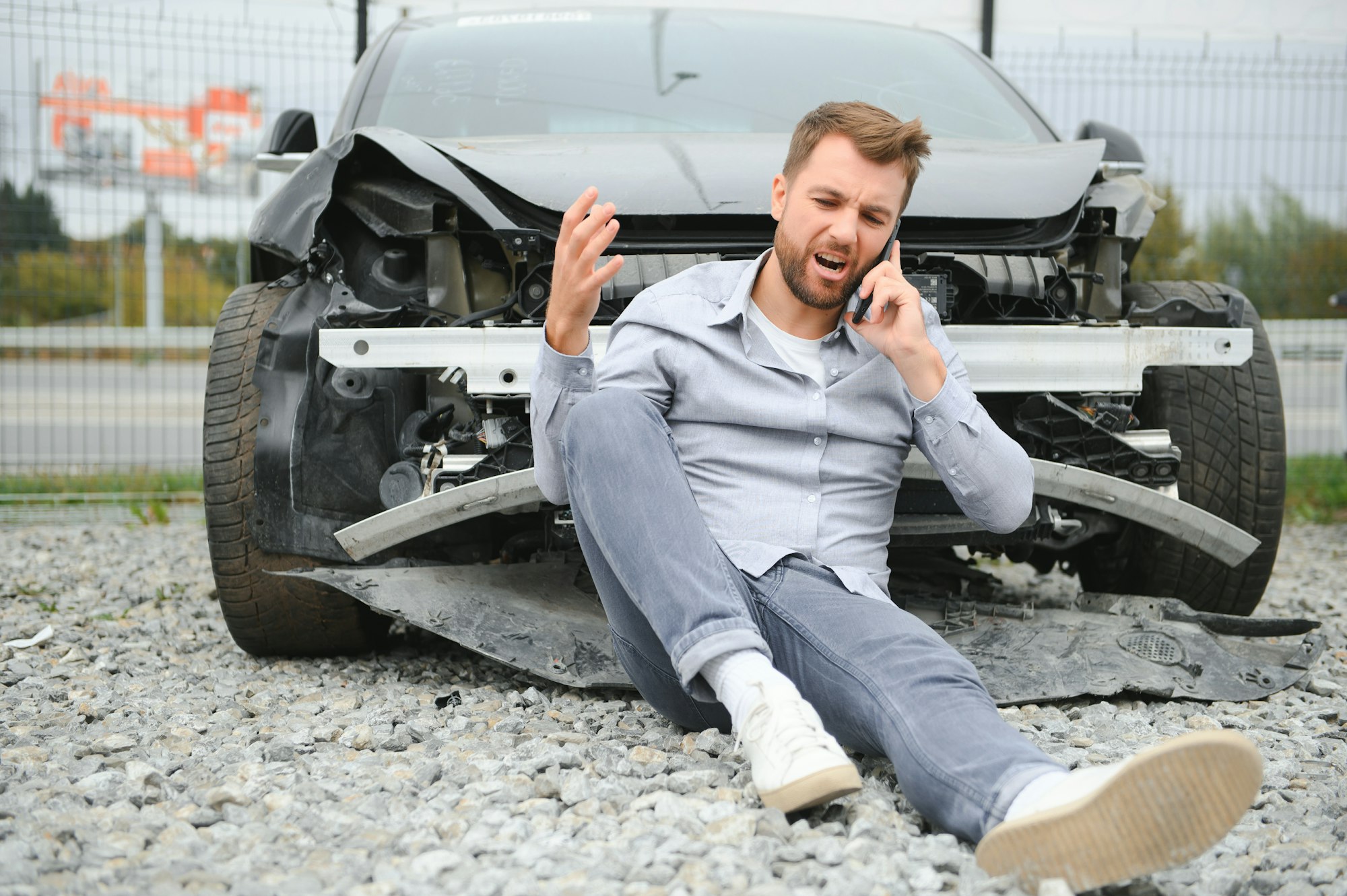 Man calling help after a car crash accident on the road