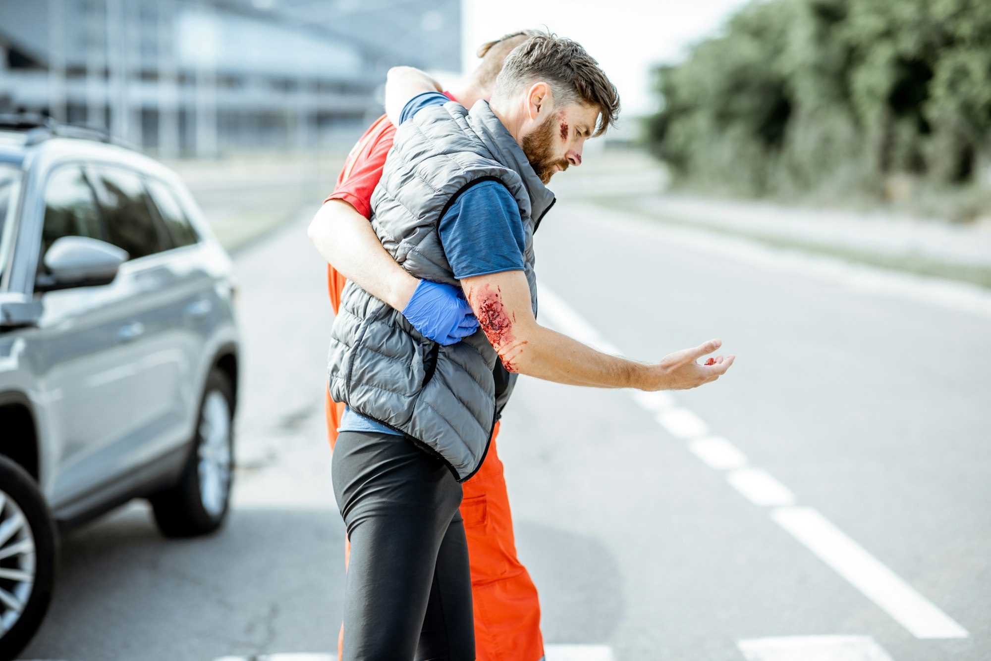 Medic walking with injured man after the accident