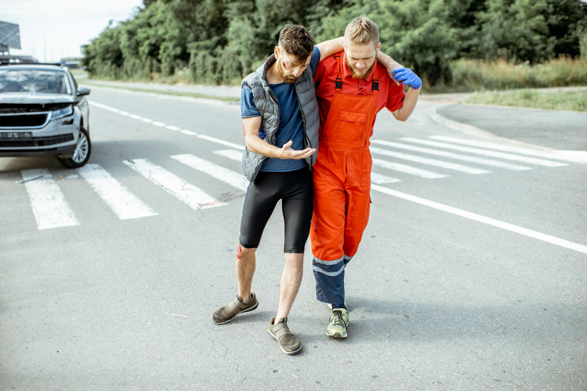Medic walking with injured man after the accident