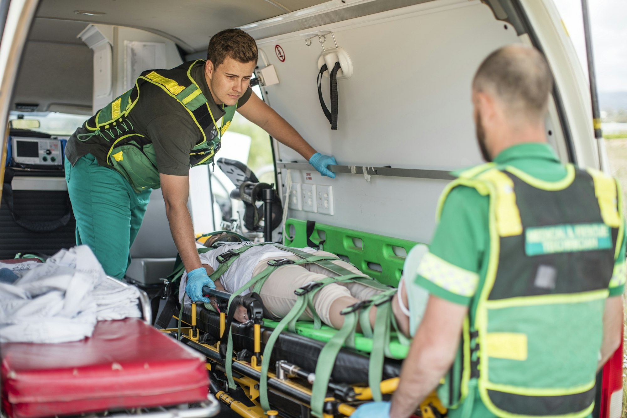 Paramedics moving car crash victim on stretcher