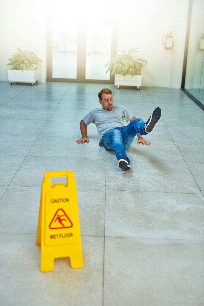 He didnt read the sign. Shot of a man cleaning an office building.