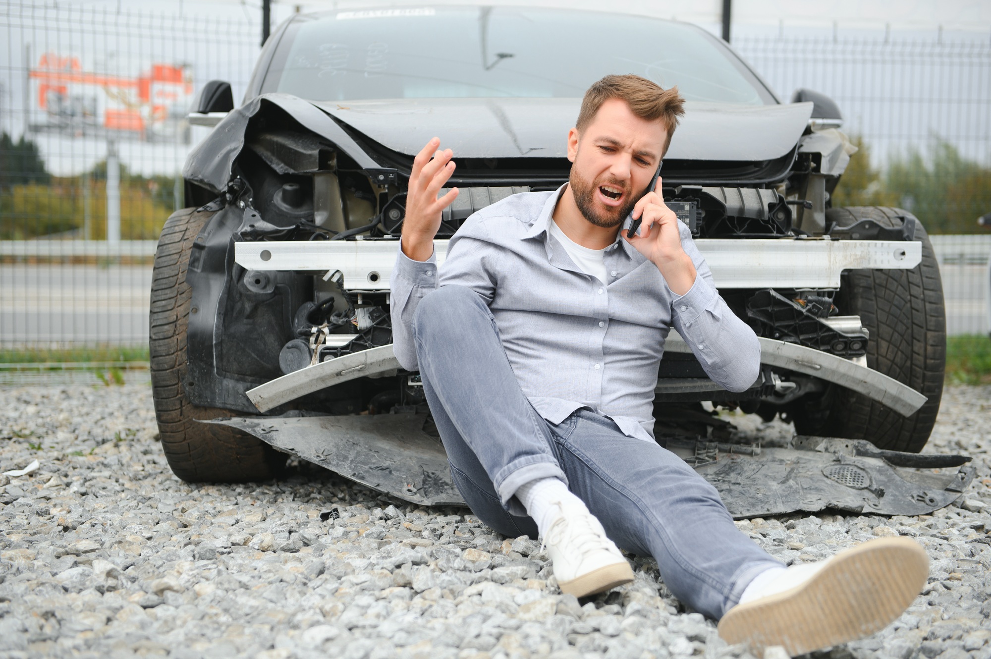 Man calling help after a car crash accident on the road