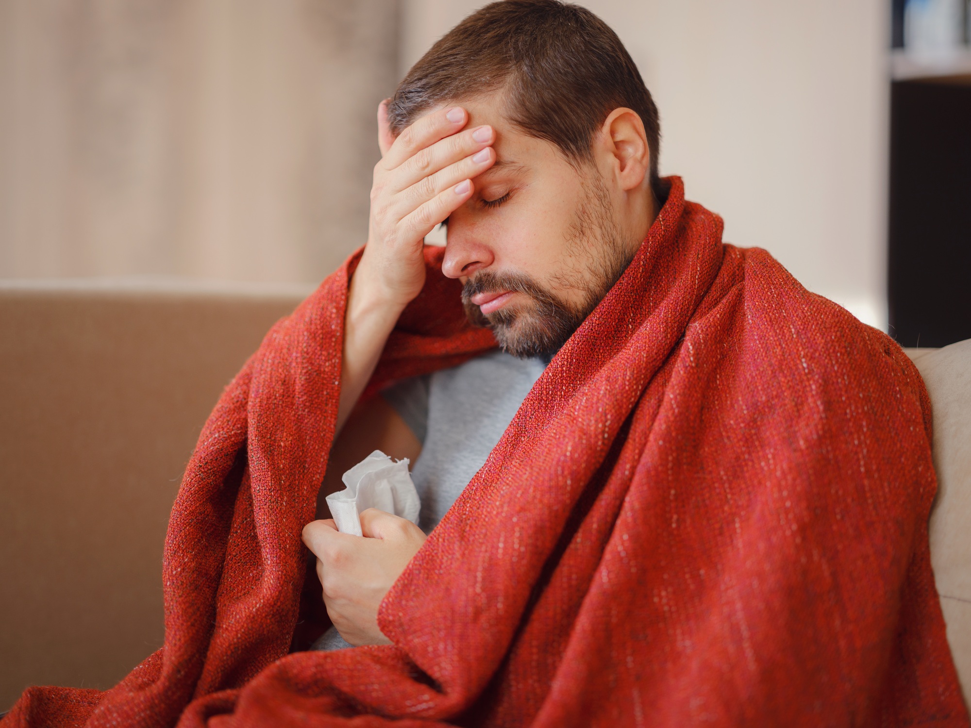 Sick man of corona virus lying down in sofa recovery from illness in home.