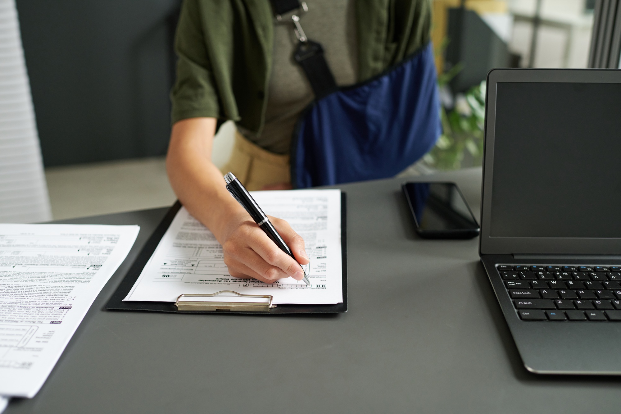 Woman with injury filing documents