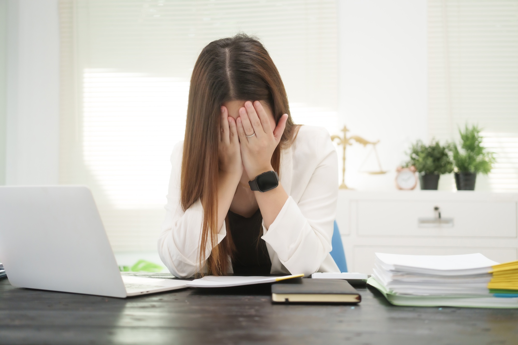 A hardworking businesswoman sits at her desk as a legal consultant, managing online justice cases