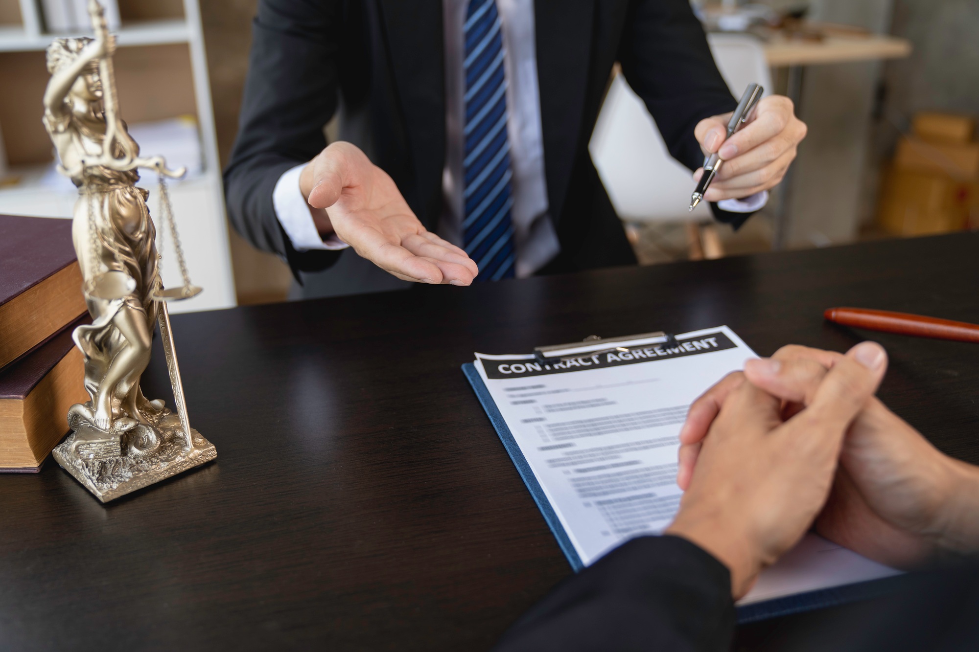 Attorney or judge consulting client's trial at attorney's office, litigation consultation ideas with
