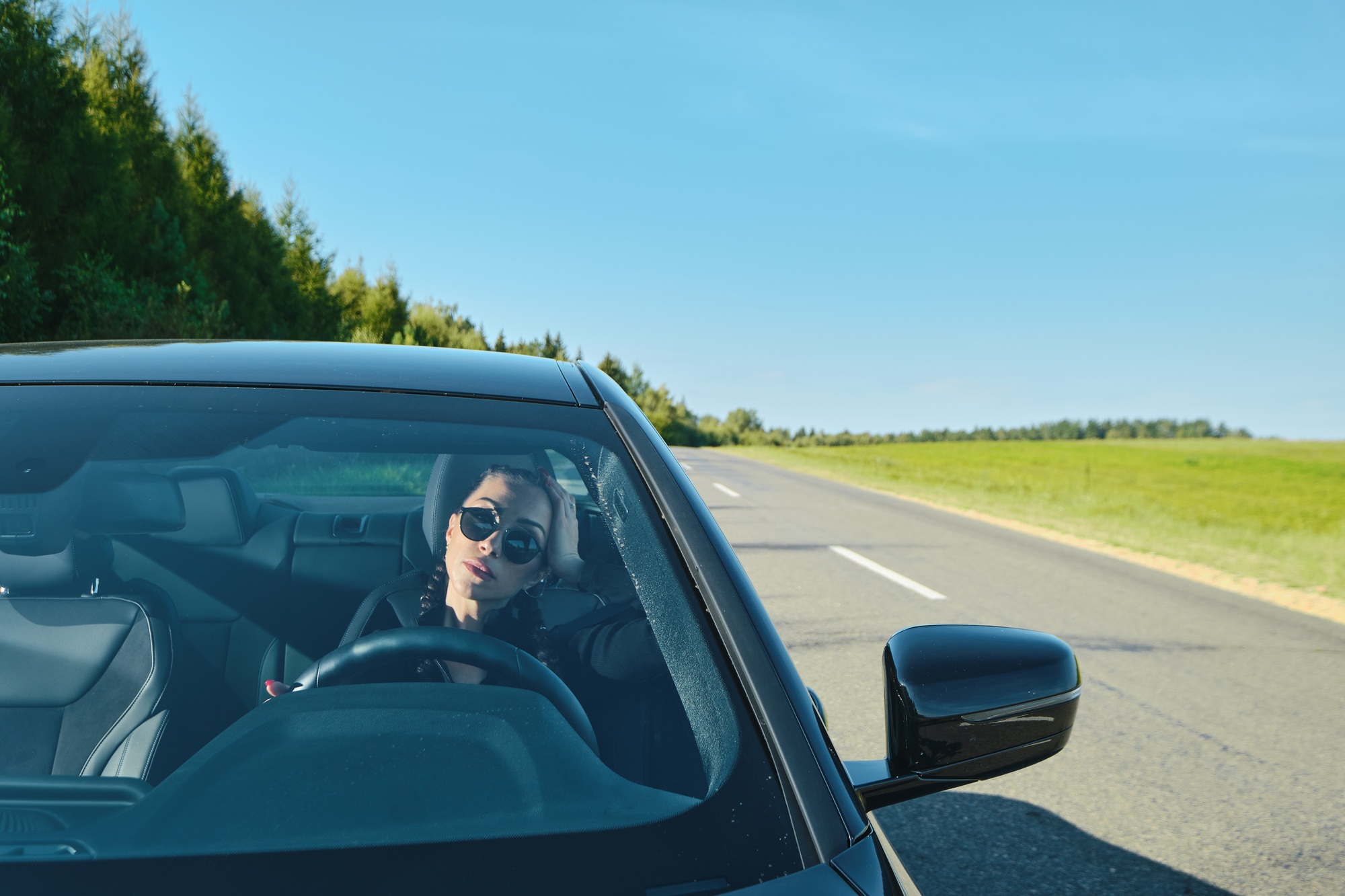 Pretty woman driving powerful car