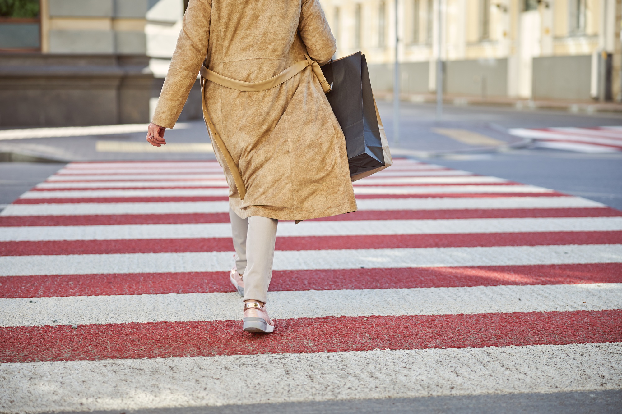 Female is walking at the pedestrian crossing
