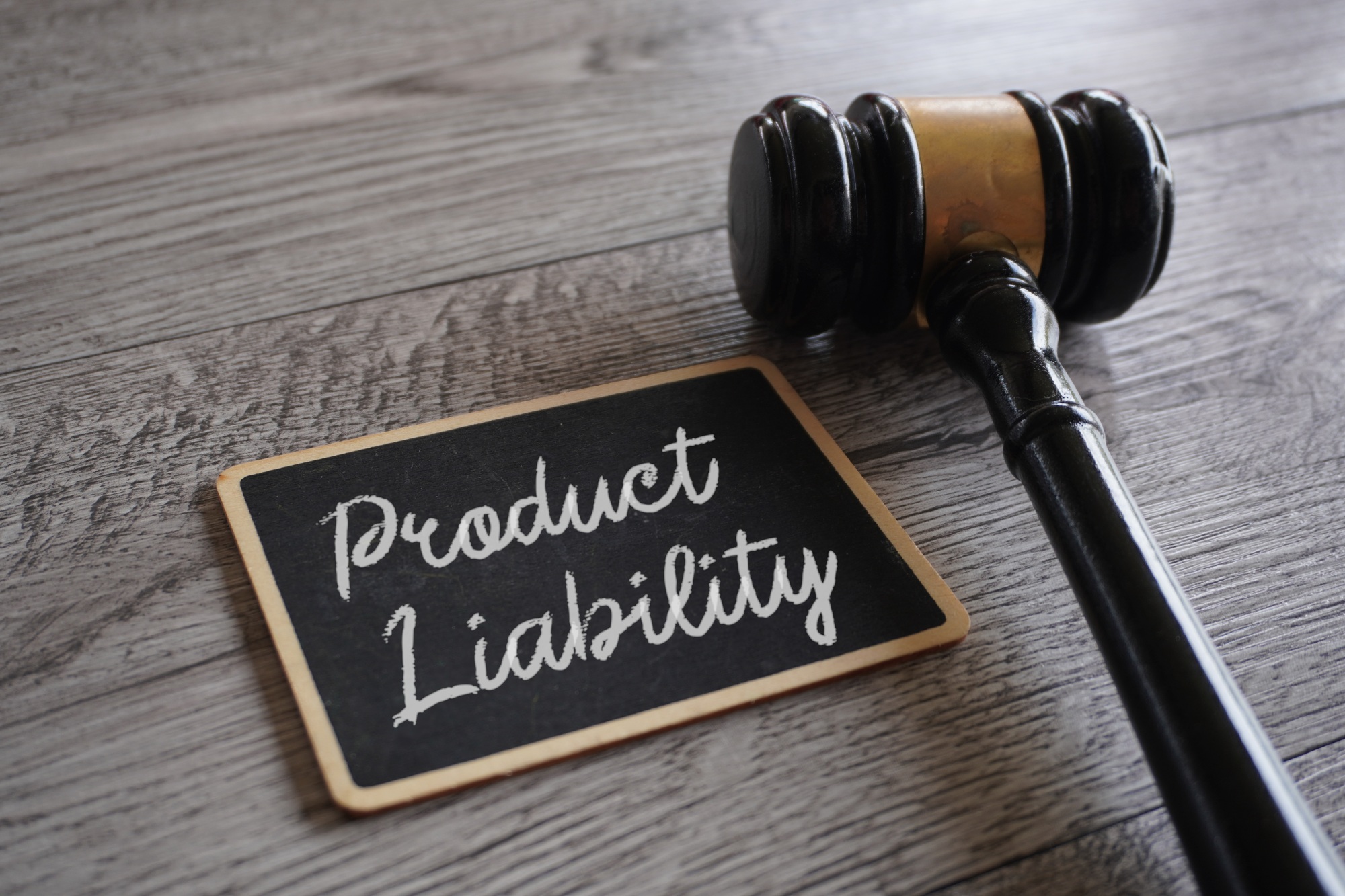 Judge gavel and text PRODUCT LIABILITY on table.