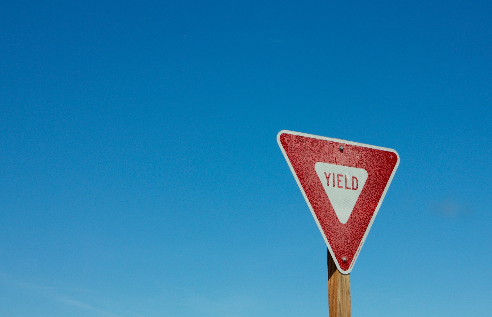 Yield sign against blue sky background room for copy