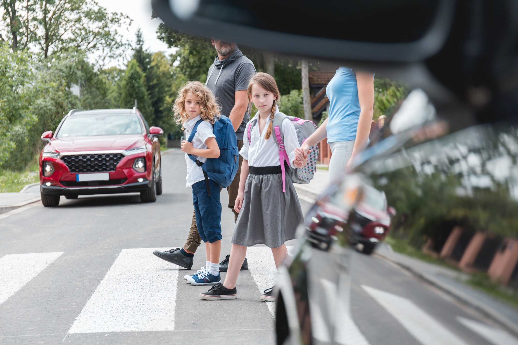 Group of children goes through the pedestrian crossing